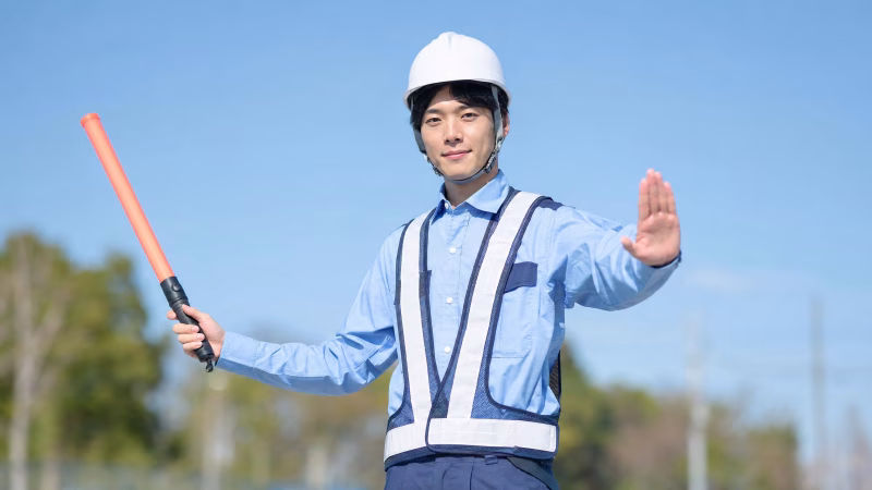 交通誘導をする警備員の男性