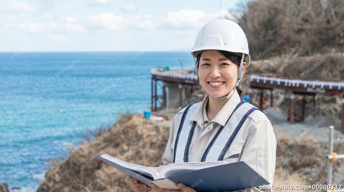 海岸沿いのインフラ・橋梁工事現場で働く女性施工管理